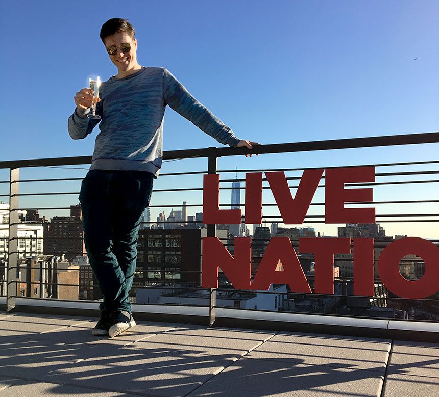 Miami Ad School art direction graduate GT Smith toasts his new career on the rooftop of Live Nation headquarters in New York City.